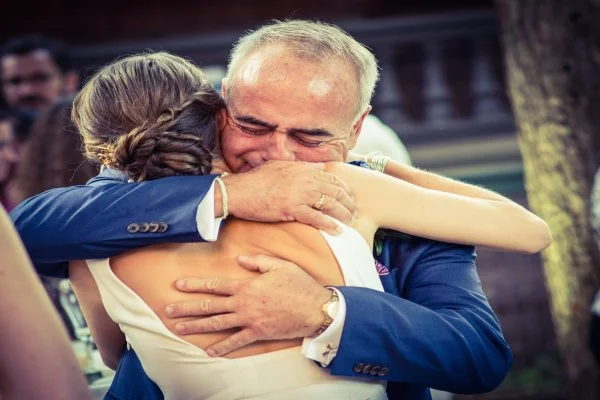 Father embracing the bride at a wedding reception at The Inn at Centre Park